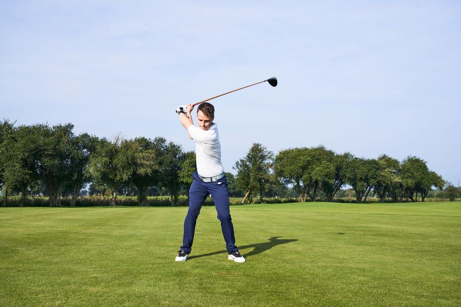 golf player hit ball with driver