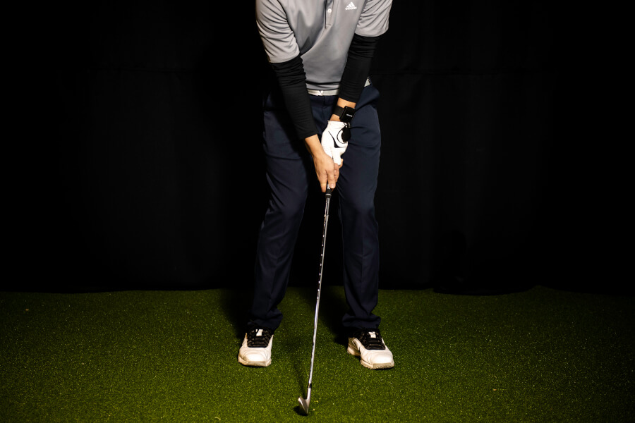 golf player training with iron at home